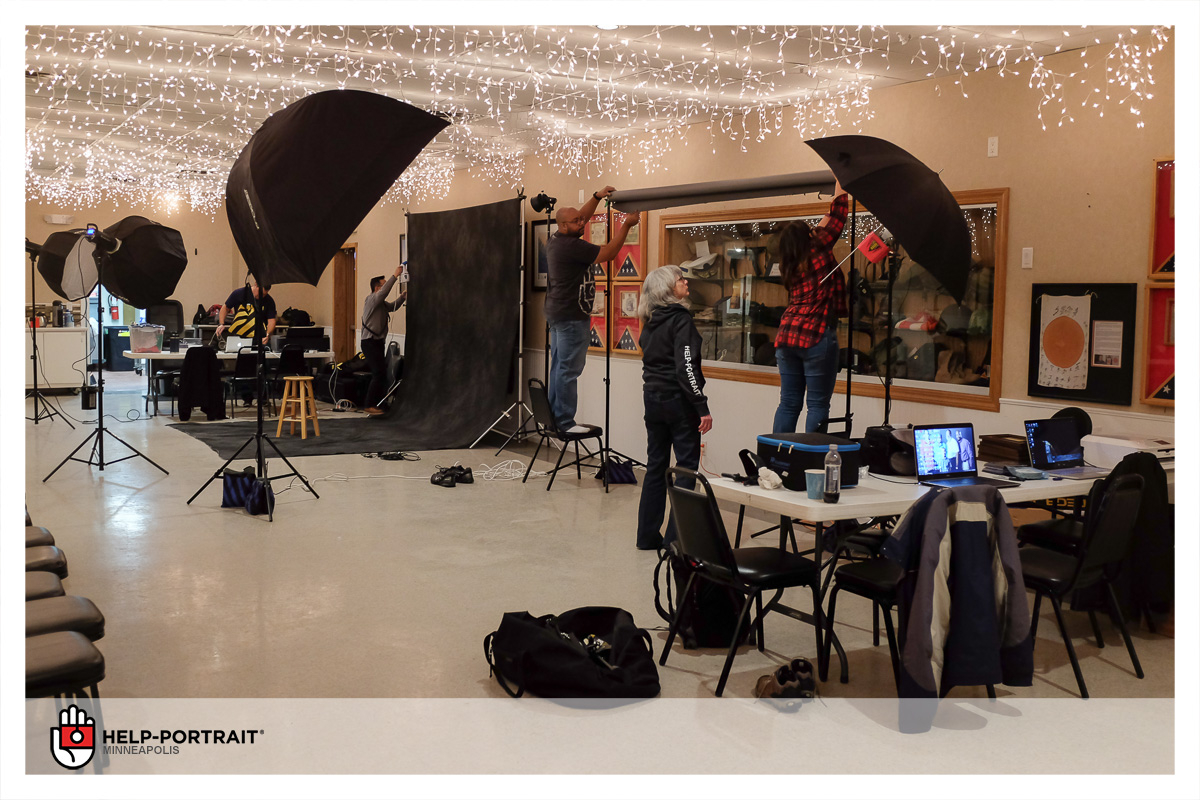 Photographers setting up lights for the Help-Portrait event.