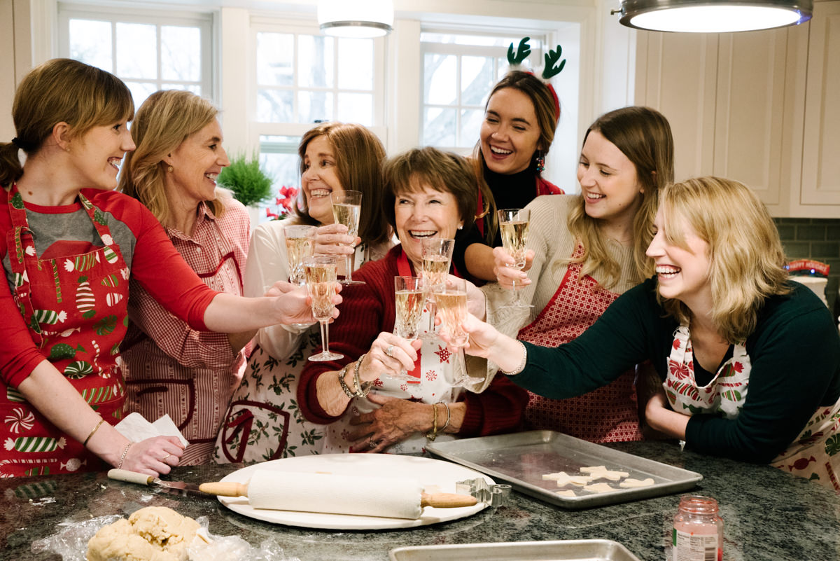 Extended family cheers of champagne in holiday video.