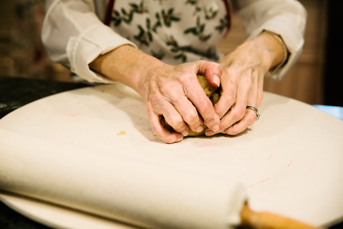 Photograph of woman's hands kneading dough.