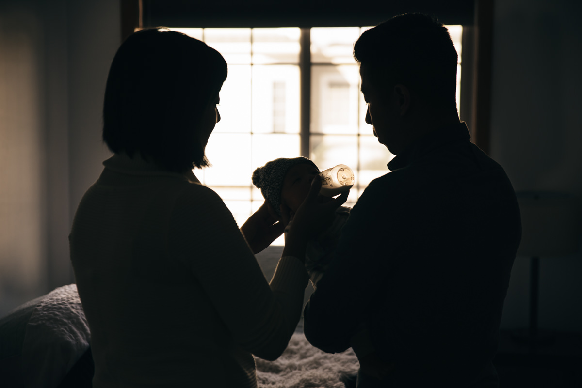 Silhouette of parents and newborn. Minnetonka in-home photography and film.