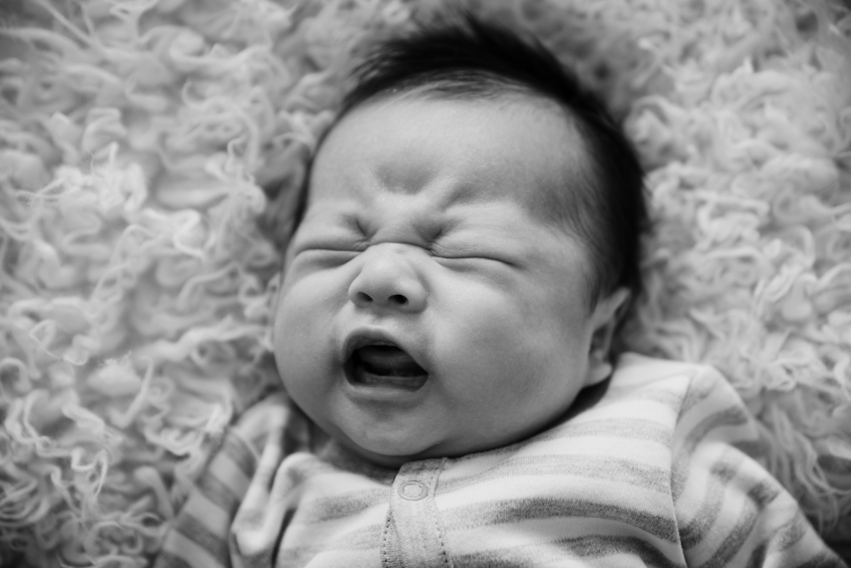 Minnetonka in-home photography and film session. Newborn crying in black and white