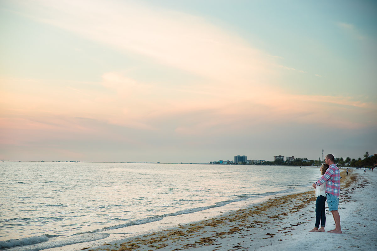 Couple walks along the water at Fort Myers Beach.