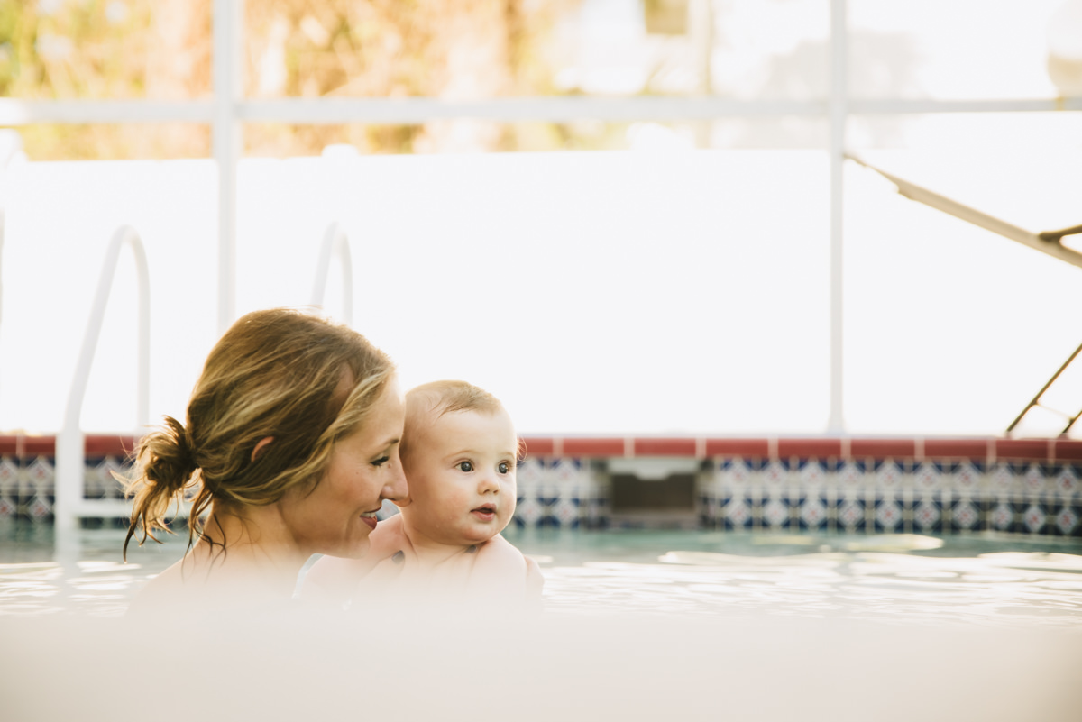 Traveling family photographer. Mother and son in pool.