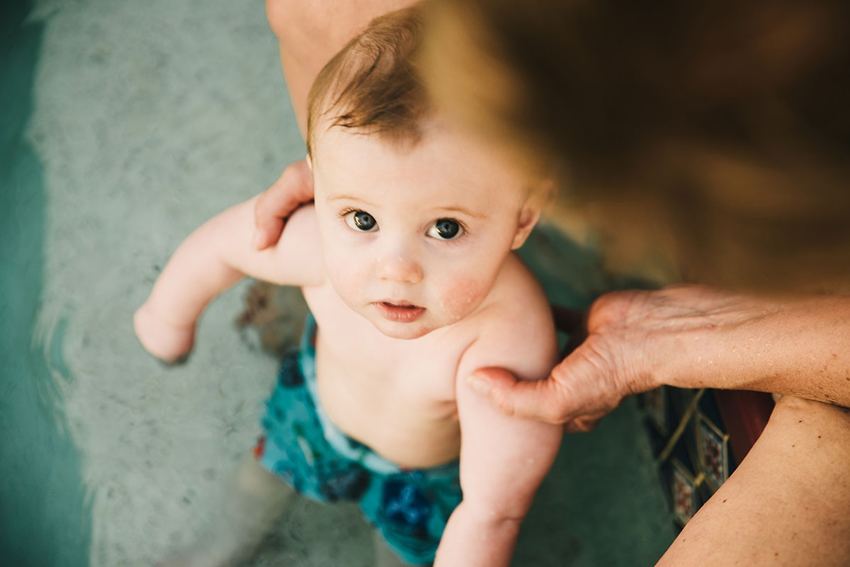 Little boy looks up at camera. Traveling family photographer.