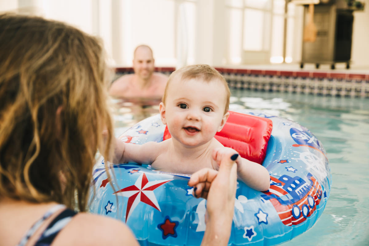 Family swims in pool. Traveling family photographer.