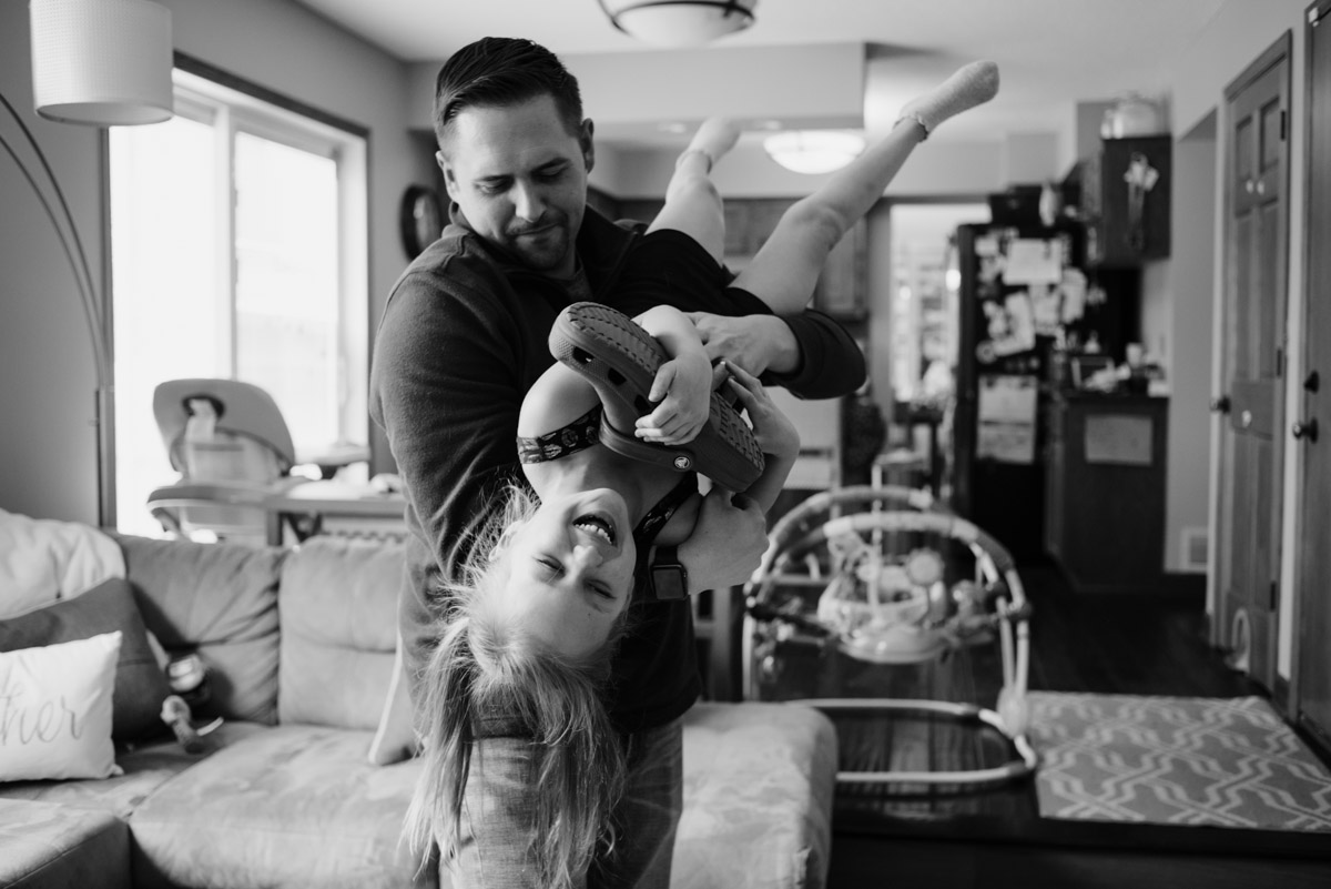 Dad & daughter playing in the living room.