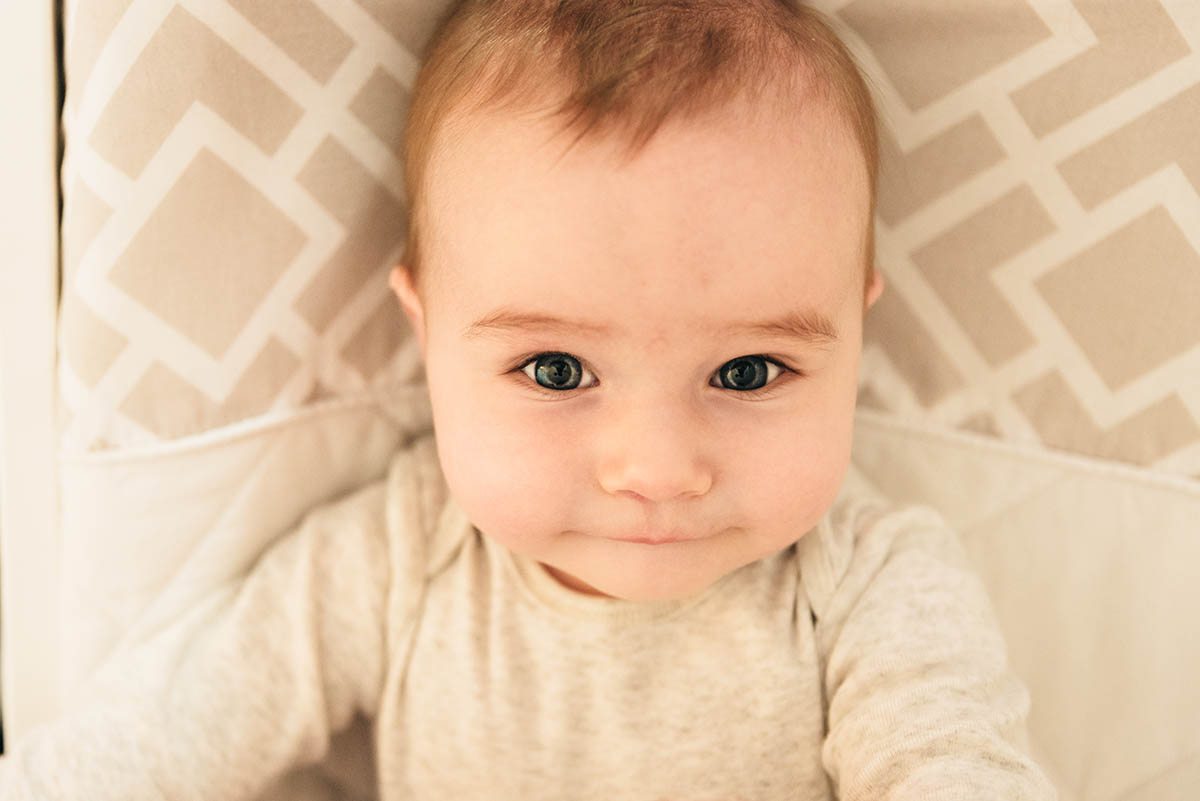 Image of baby boy laying on his back during Minnesota family video story.