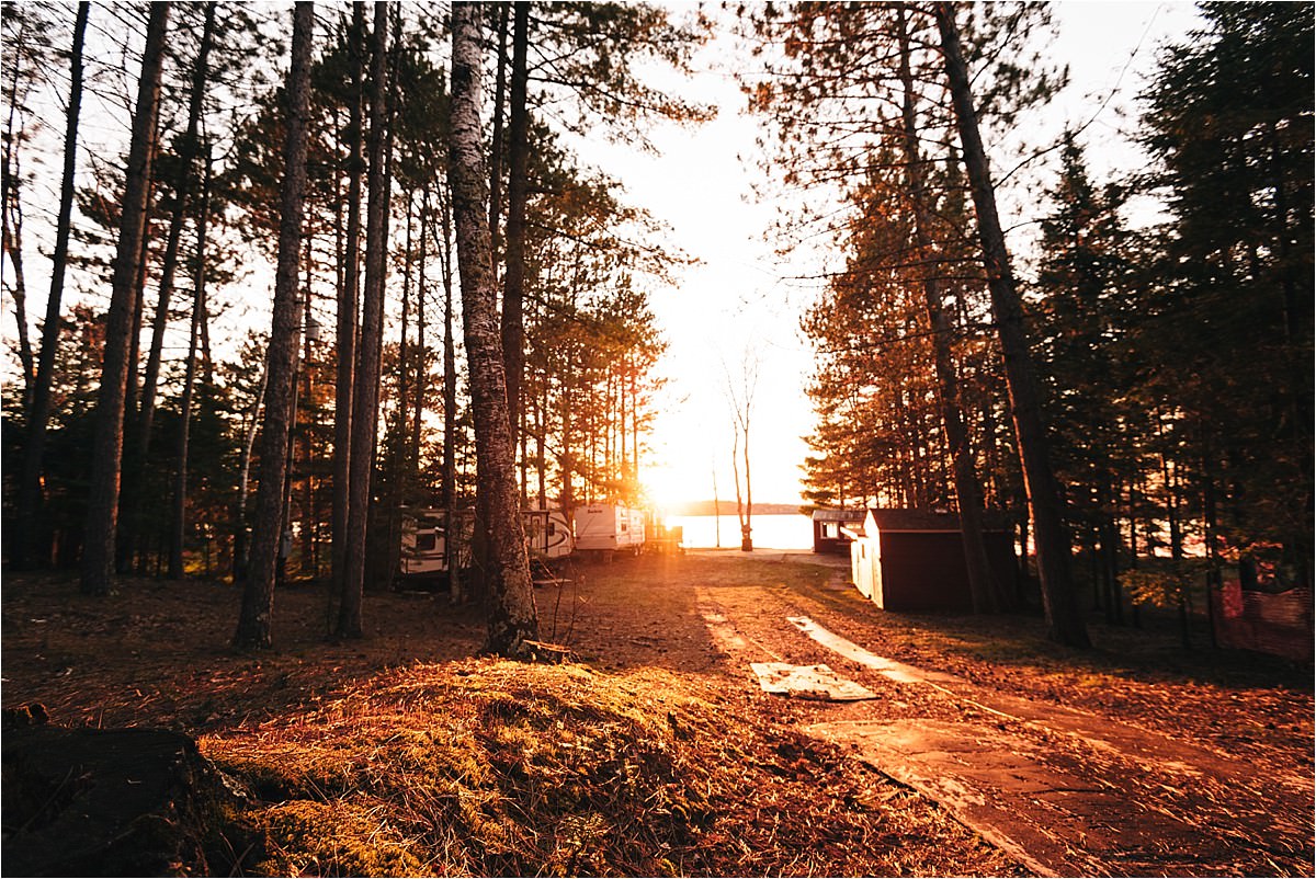 Sunset spills over land and lake.