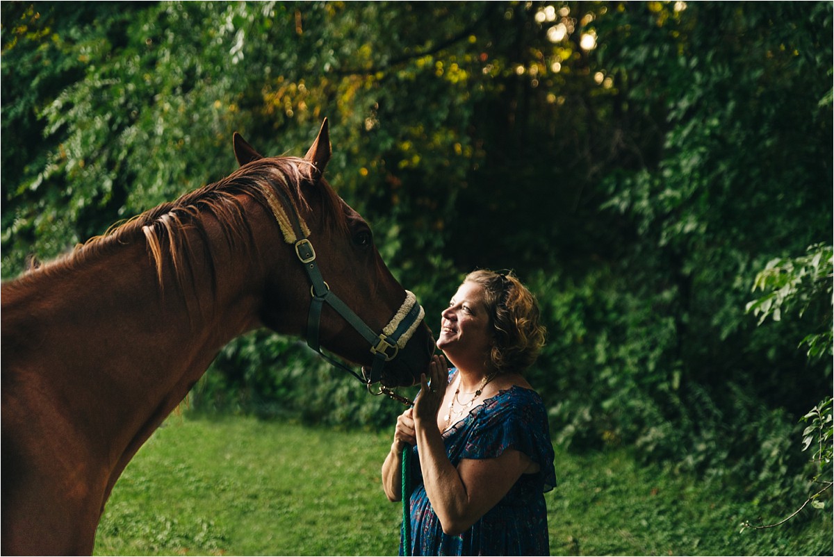 Woman looks up at her horse at Bea Hive Farm photogarphy.