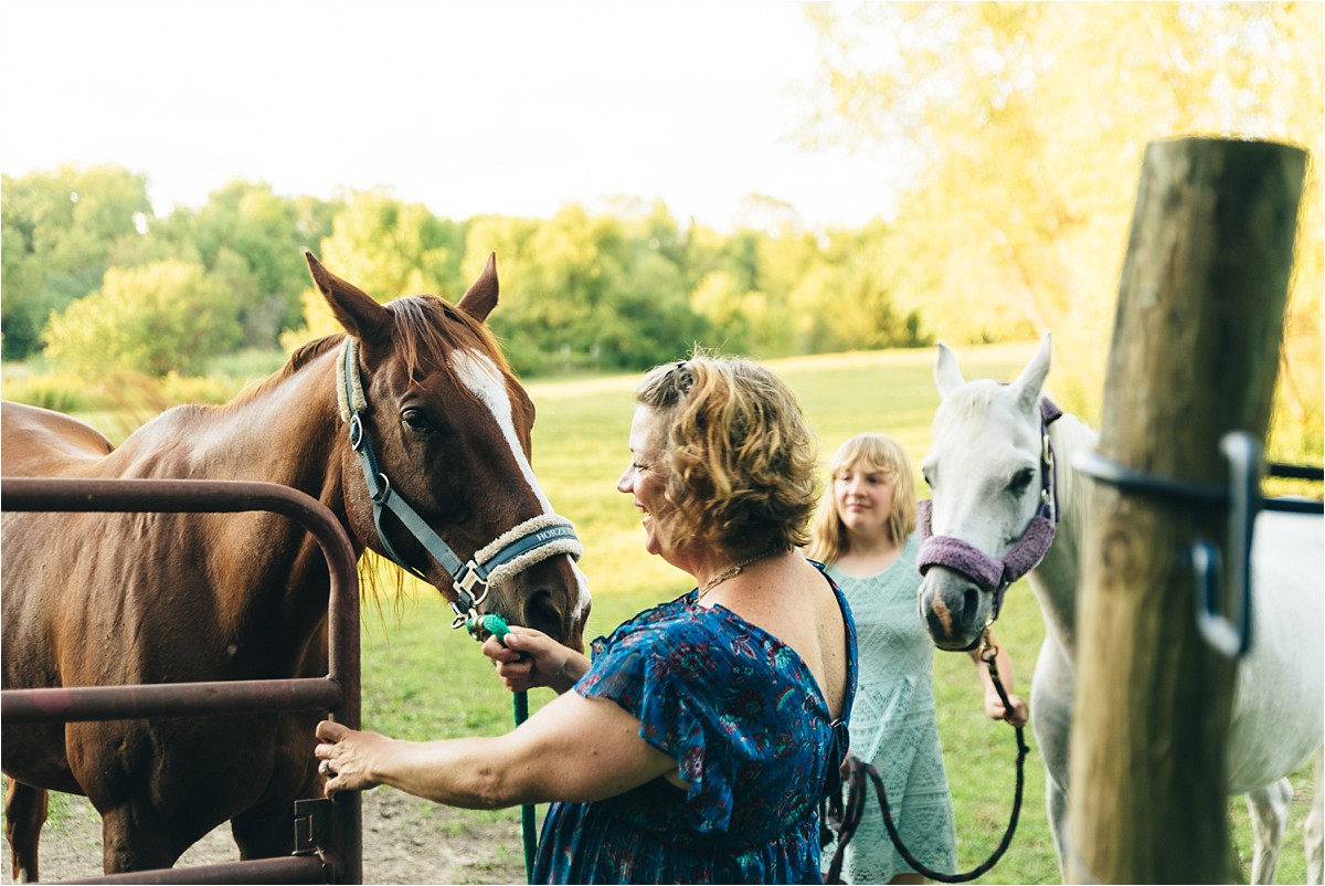 Mother and daughter wrangle horses.