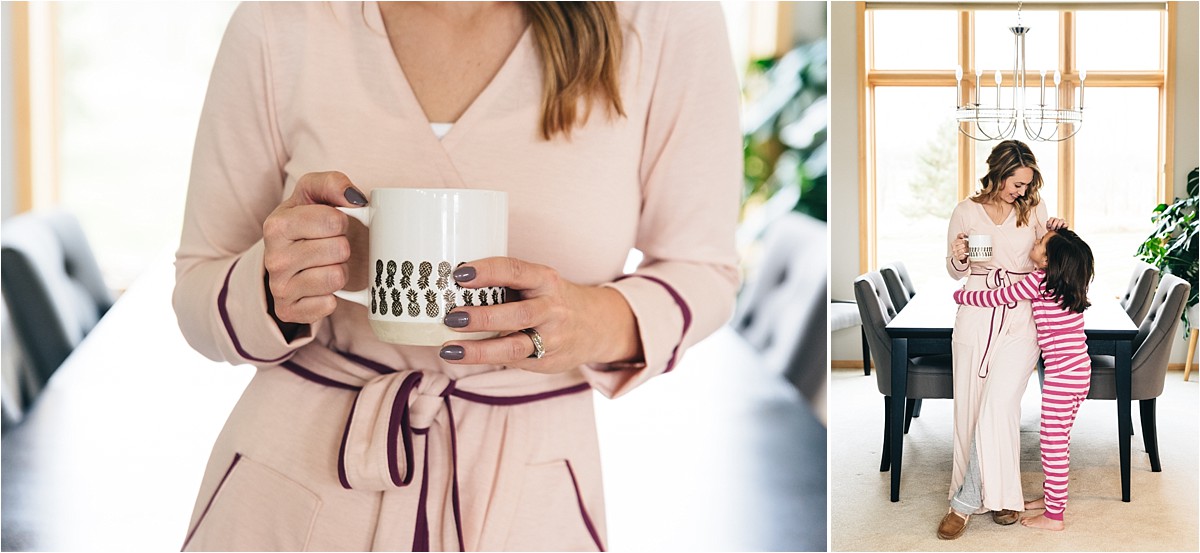 Woman with pink robe holds coffee mug.