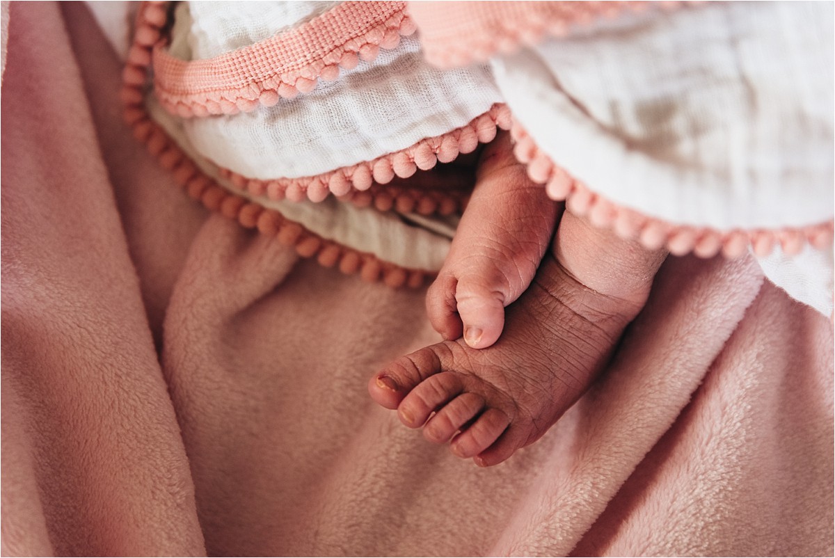 Photograph of newborn baby feet.