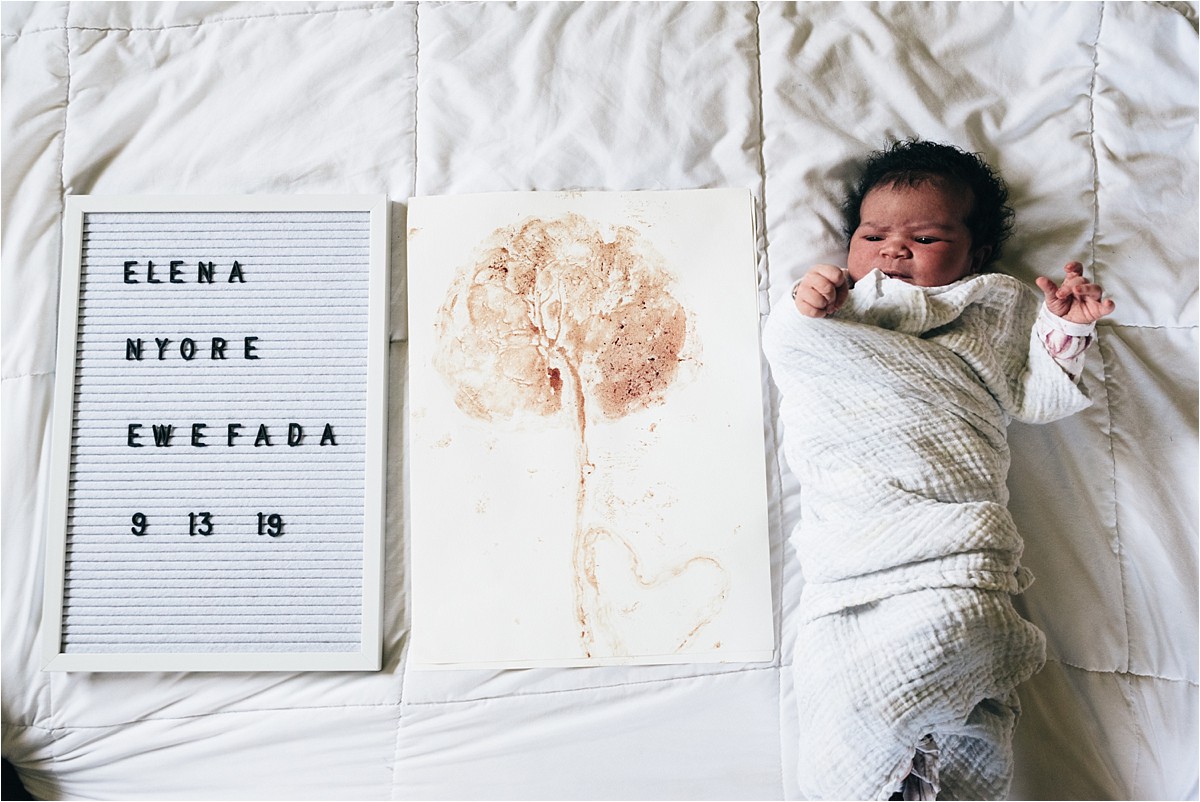 Baby with photos and letter board.