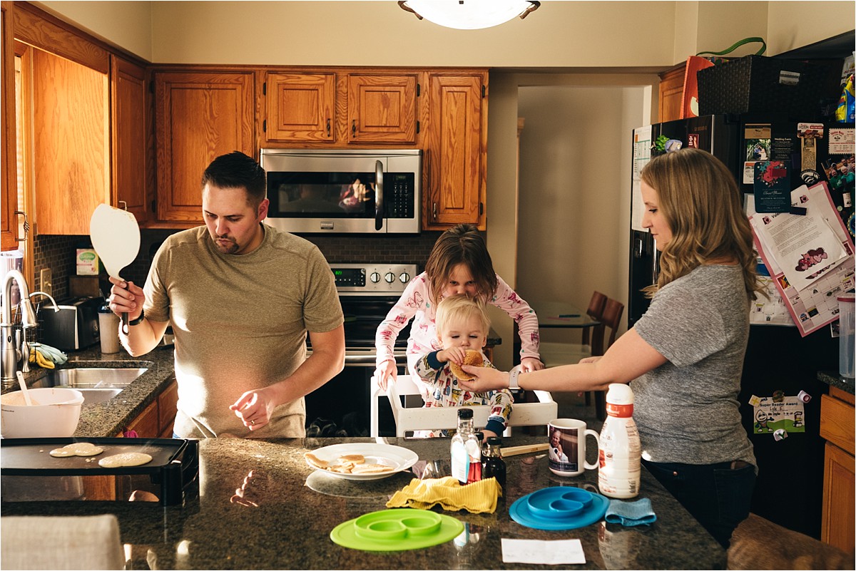 Family makes pancakes together in the kitchen during in-home lifestyle session.