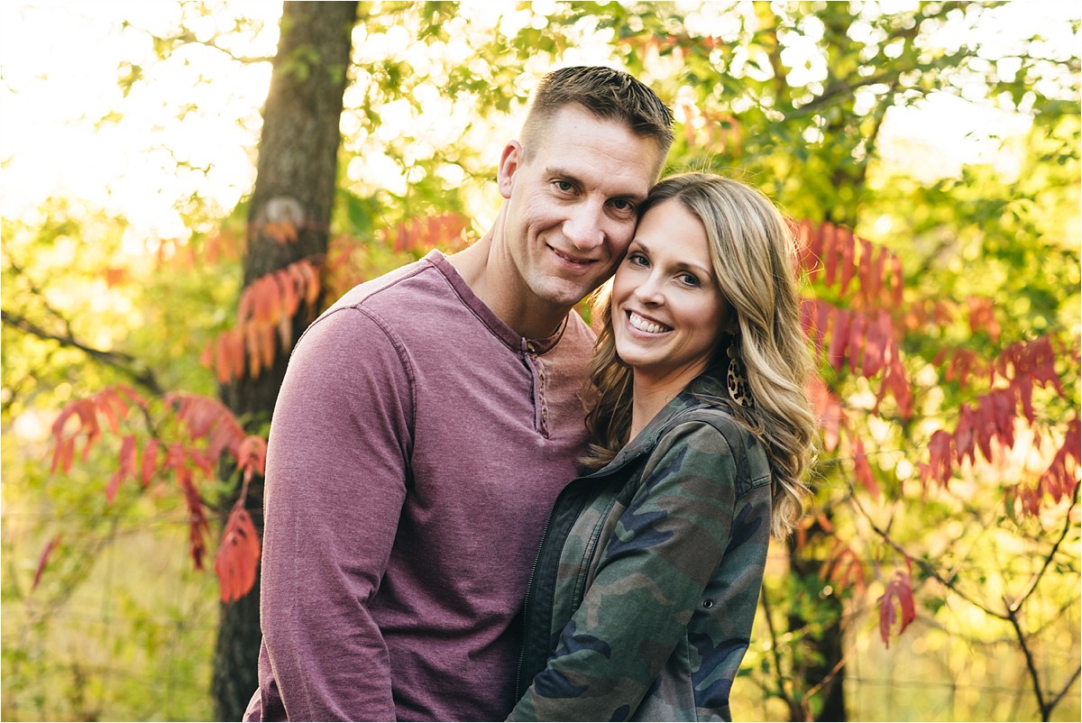  parents pose during family photos at sunset.