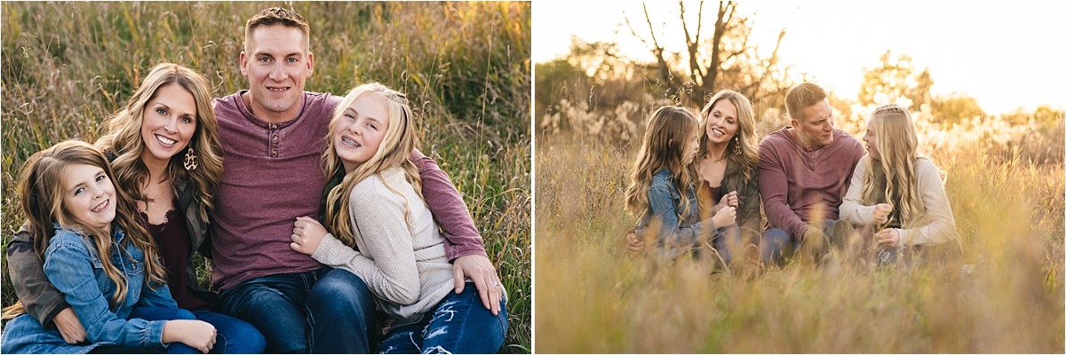 Family poses in grass at sunset.