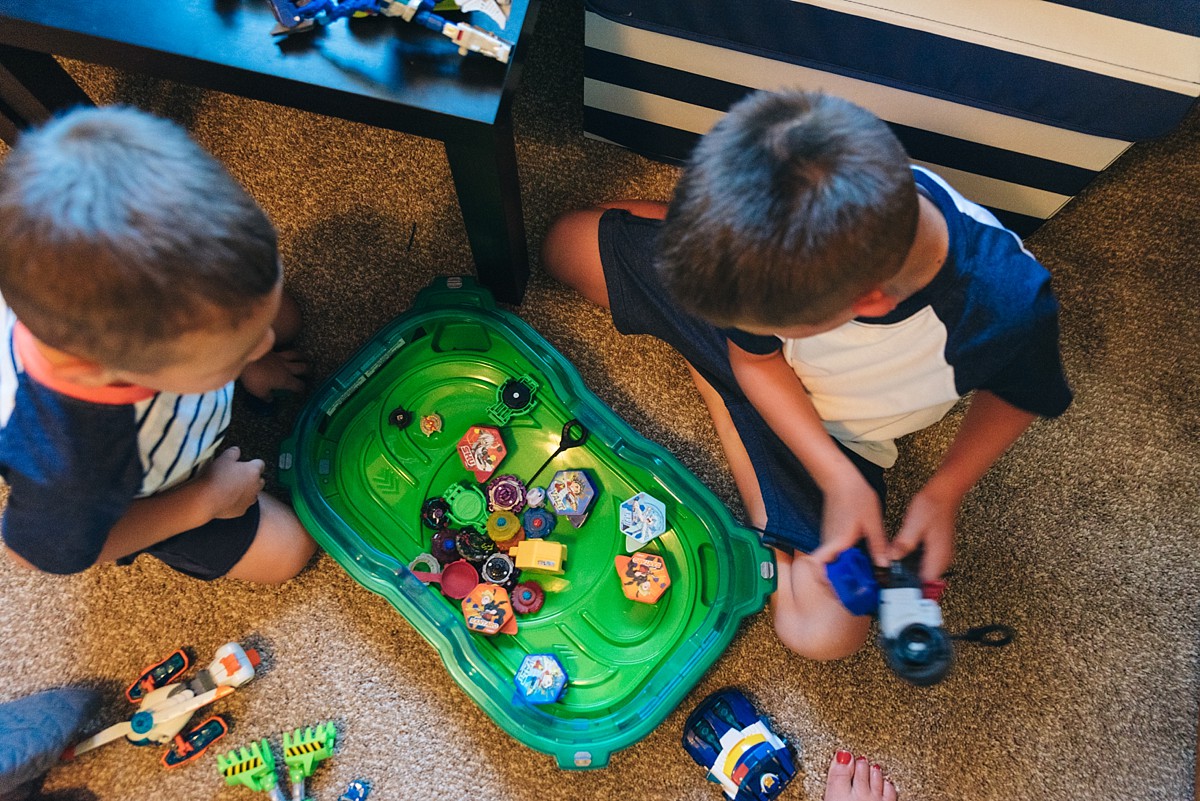 Two boys show off their toys.