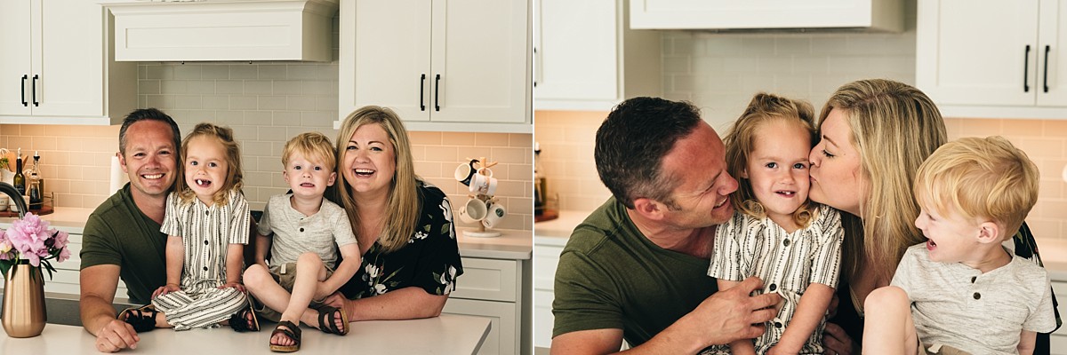 Family of four takes a photo in their kitchen.