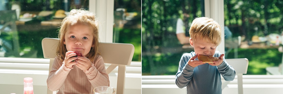 Twin siblings both eat pancakes near the window in Minnesota Family Video.