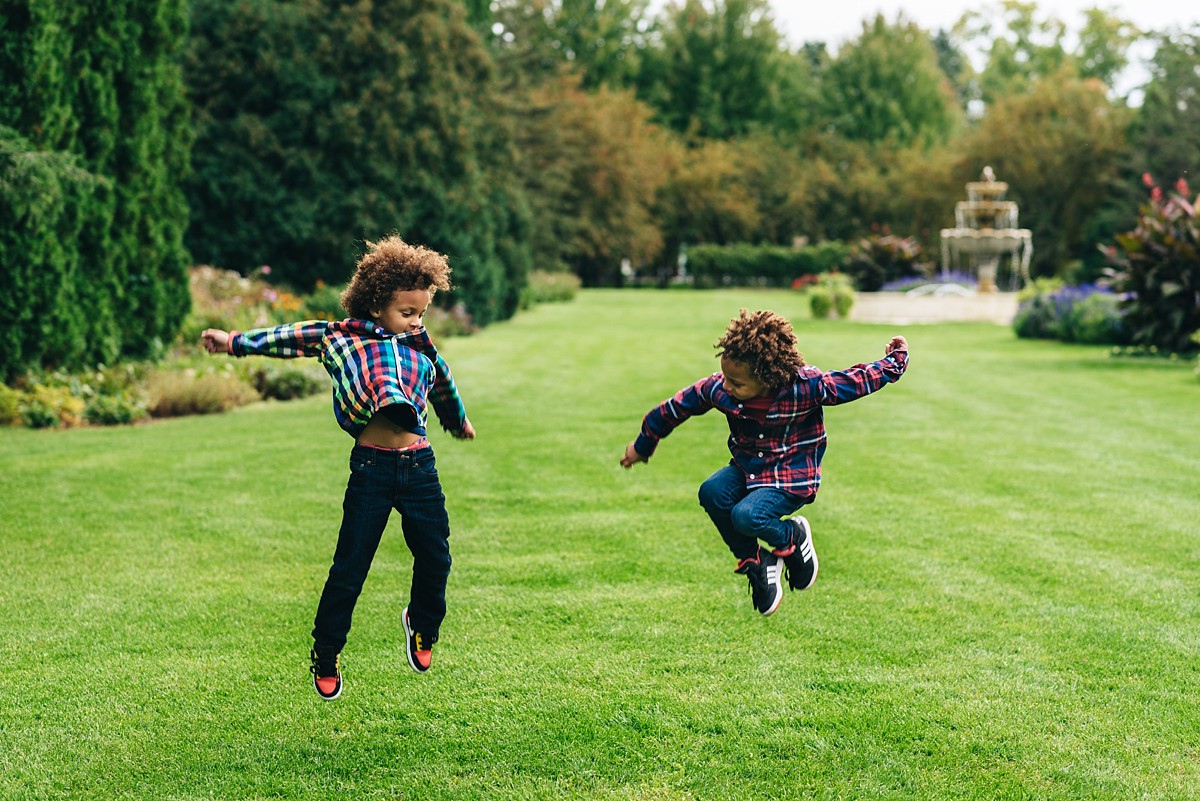 Let kids be themselves. kids cooperate during photos. Boys jumping near fountain in park