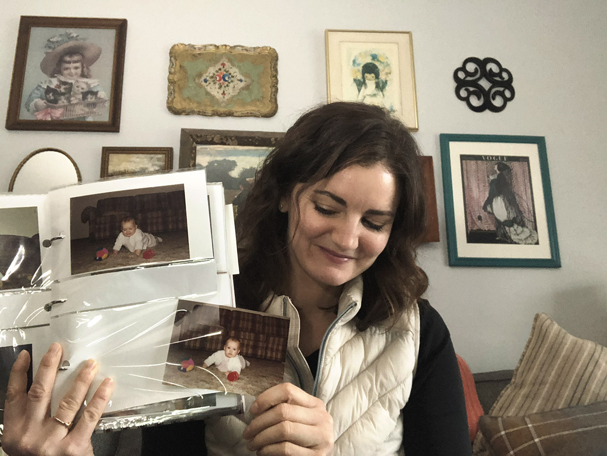 Jen Martodam holds up classic print album.