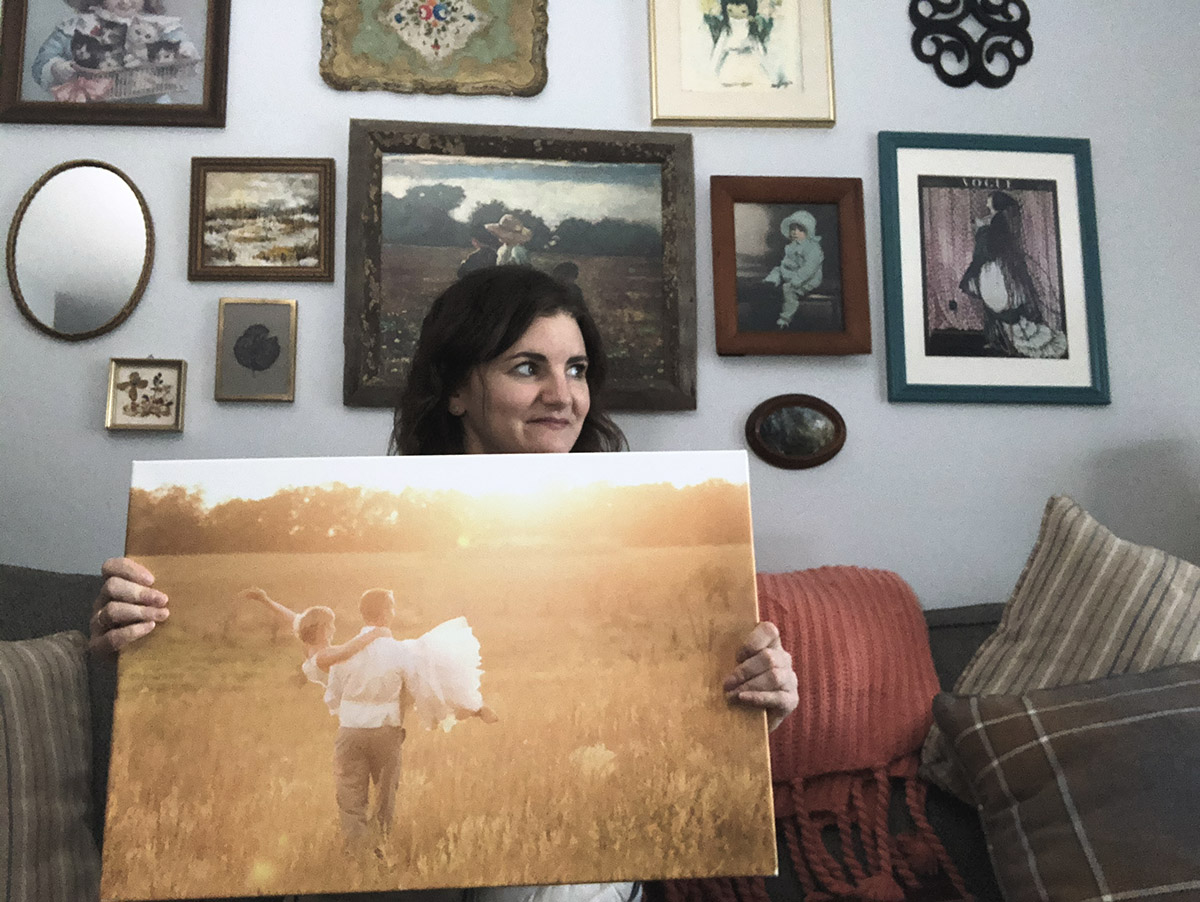 Jen Martodam holds up canvas wrap.