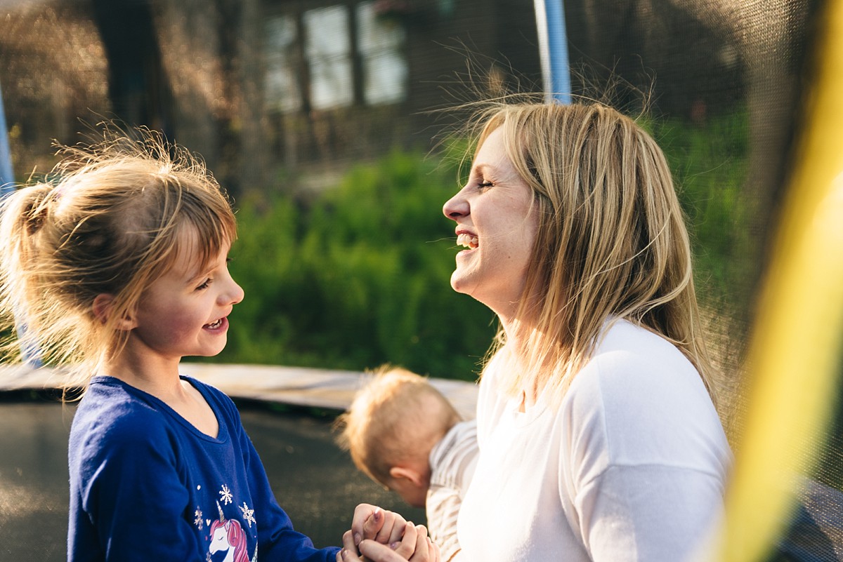 Minnesota family plays on trampoline during family film.