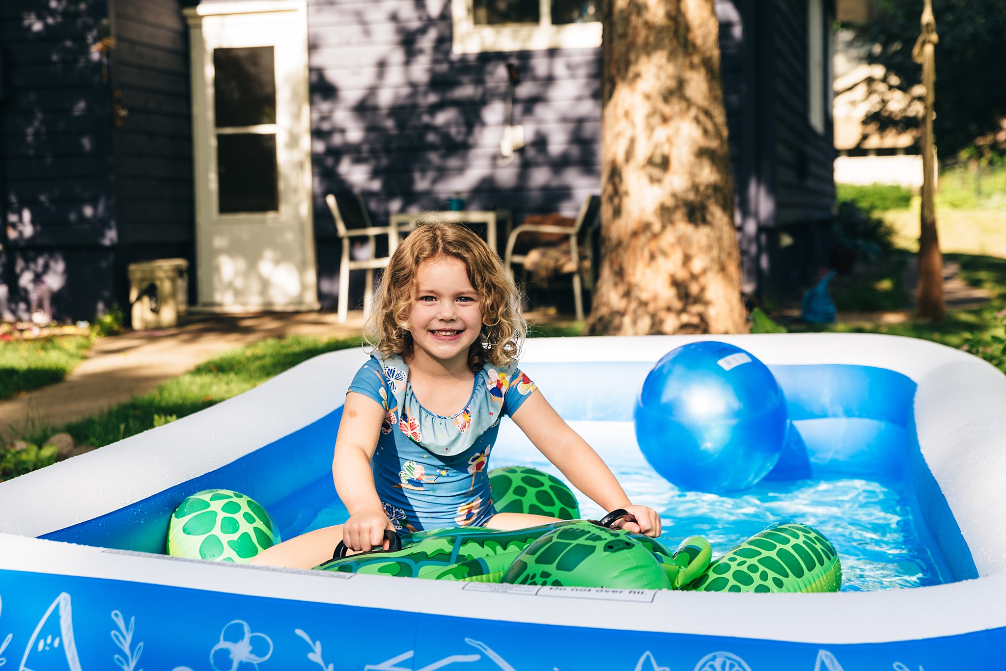 Little girl plays in backyard kiddie pool. Edina family video.