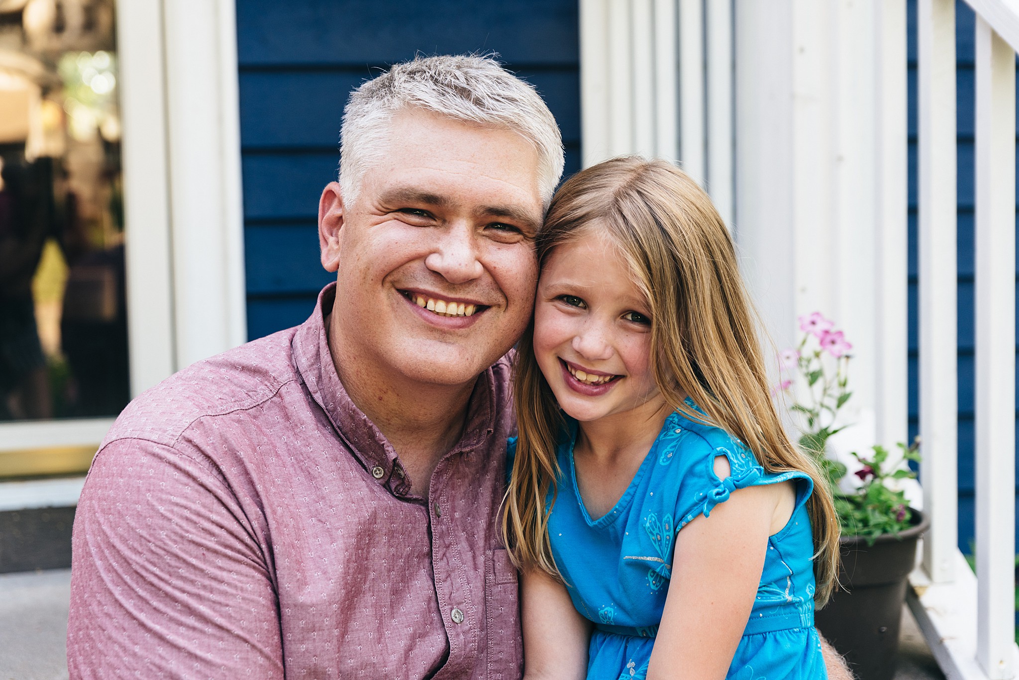 Father & daughter on a porch posing for a photo. Edina family film