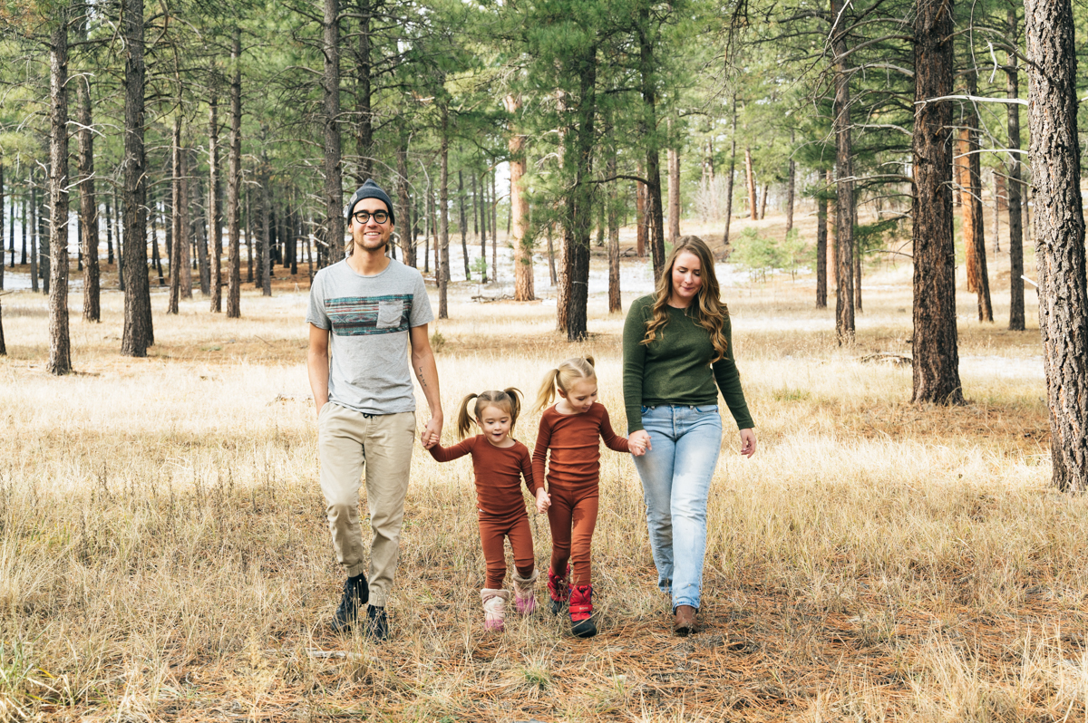 Family of four walks hand in hand during Flagstaff family film.