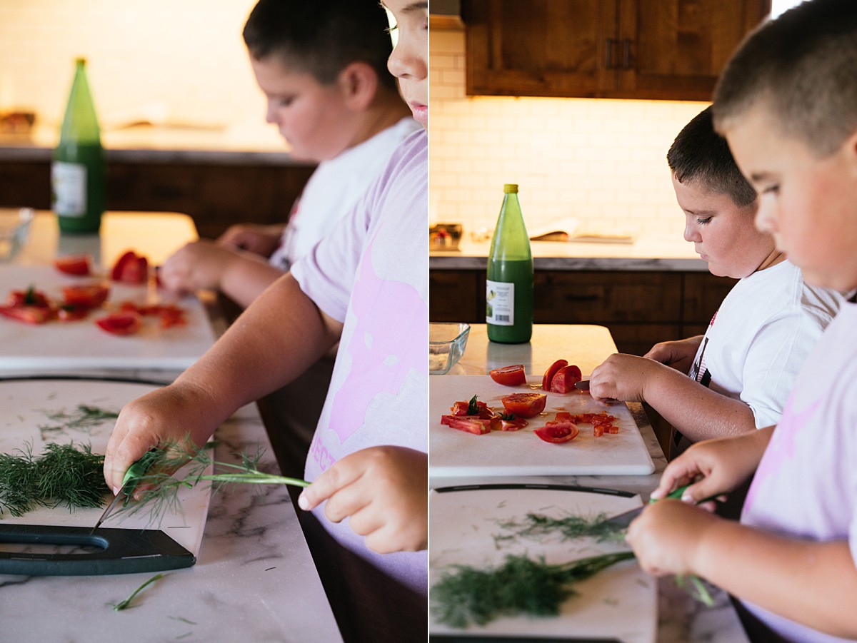 Two small boys cut vegetables in the kitchen during Northwest Minnesota family film.