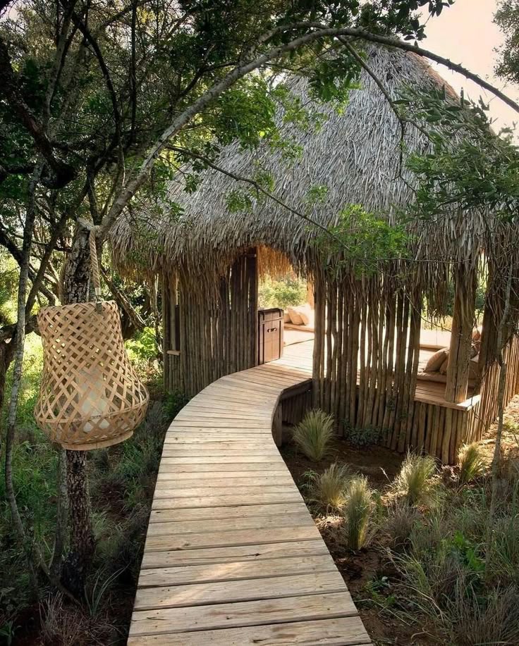 Wooden path surrounded by dense tropical trees and greenery on Sumba Sunset Cliff, symbolizing natural beauty and sustainable, low-impact development.