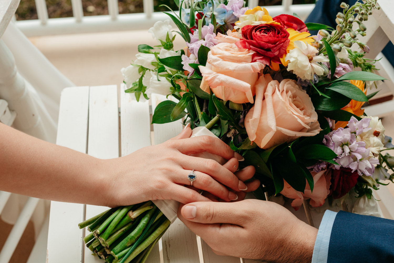 Married couple holding bouquet 