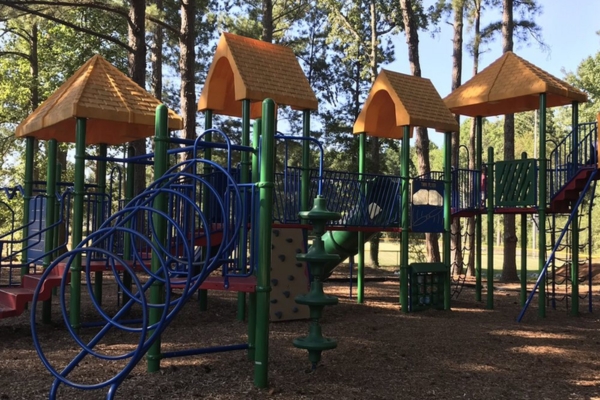 Colorful playground structure with climbing features and slides, set in a wooded park environment, ideal for infants and toddlers exploring outdoor play. Colorful playground structure with climbing features and slides, set in a wooded park environment, ideal for infants and toddlers exploring outdoor play.
