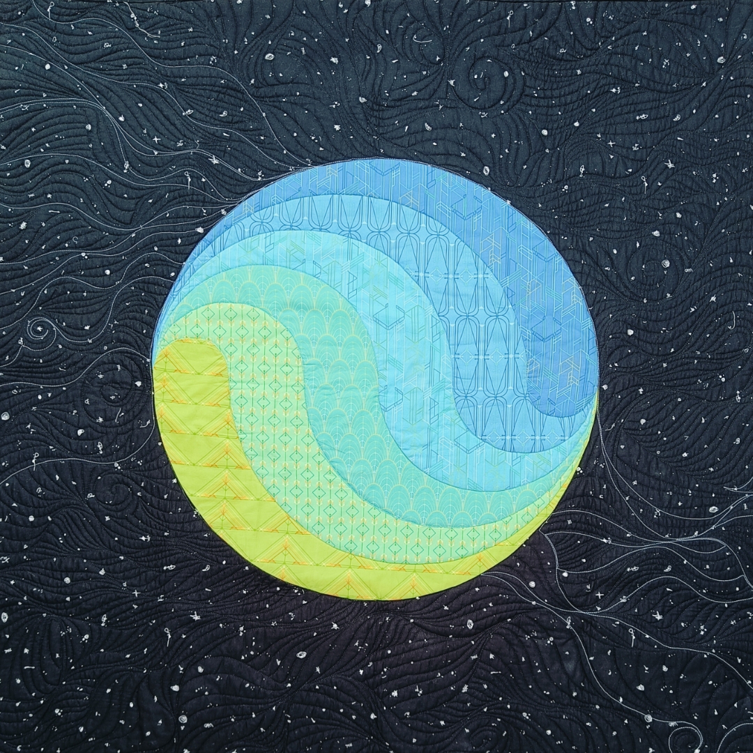 Strata Flow quilt pattern by Helen Creasey of And Sew I – curving layers of blue and yellow fabric on a black quilted background Strata Flow quilt pattern by Helen Creasey of And Sew I – curving layers of blue and yellow fabric on a black quilted background