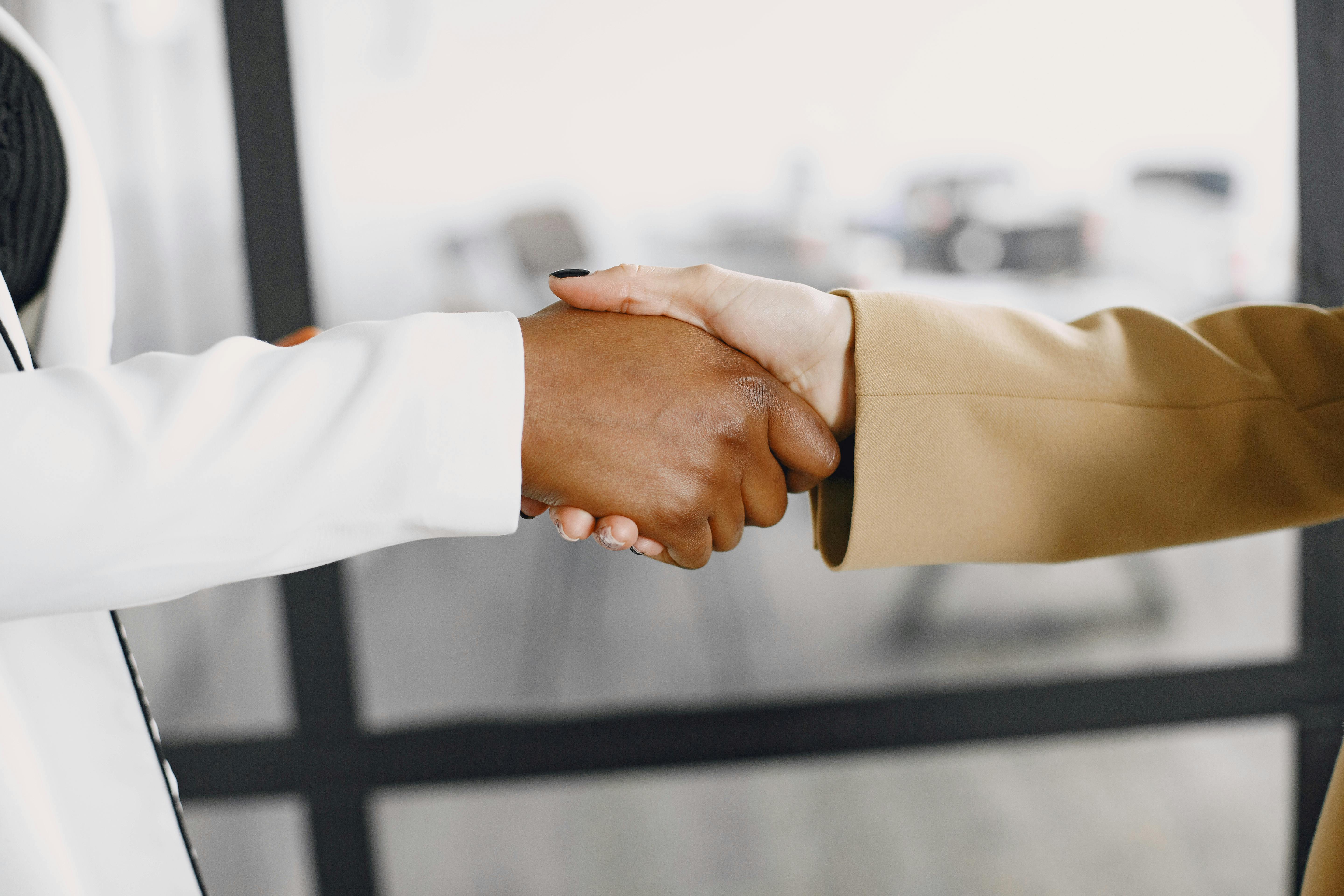 a handshake which symbolizes good partnerships a handshake which symbolizes good partnerships