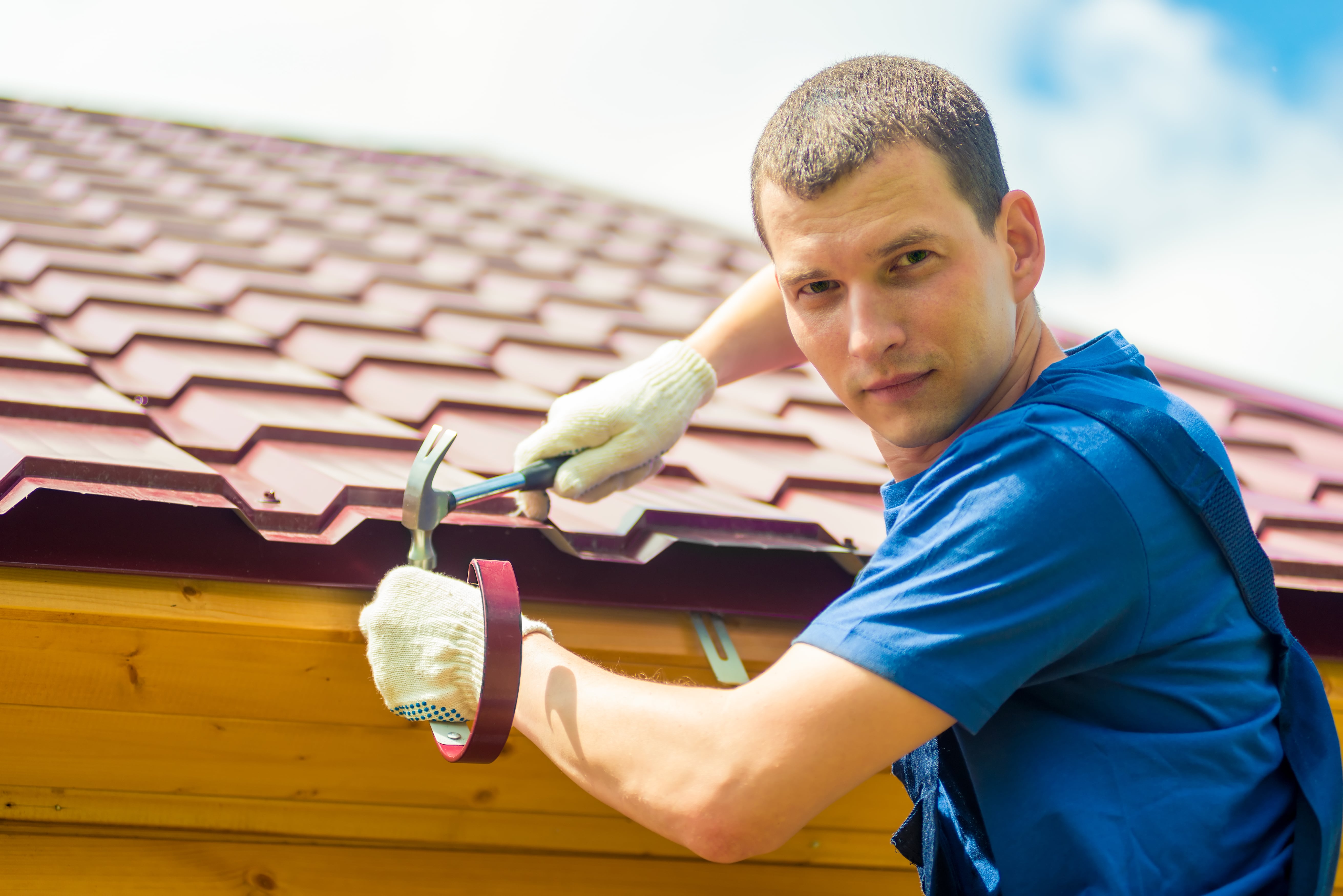 expert and professional roofers repairing a roof