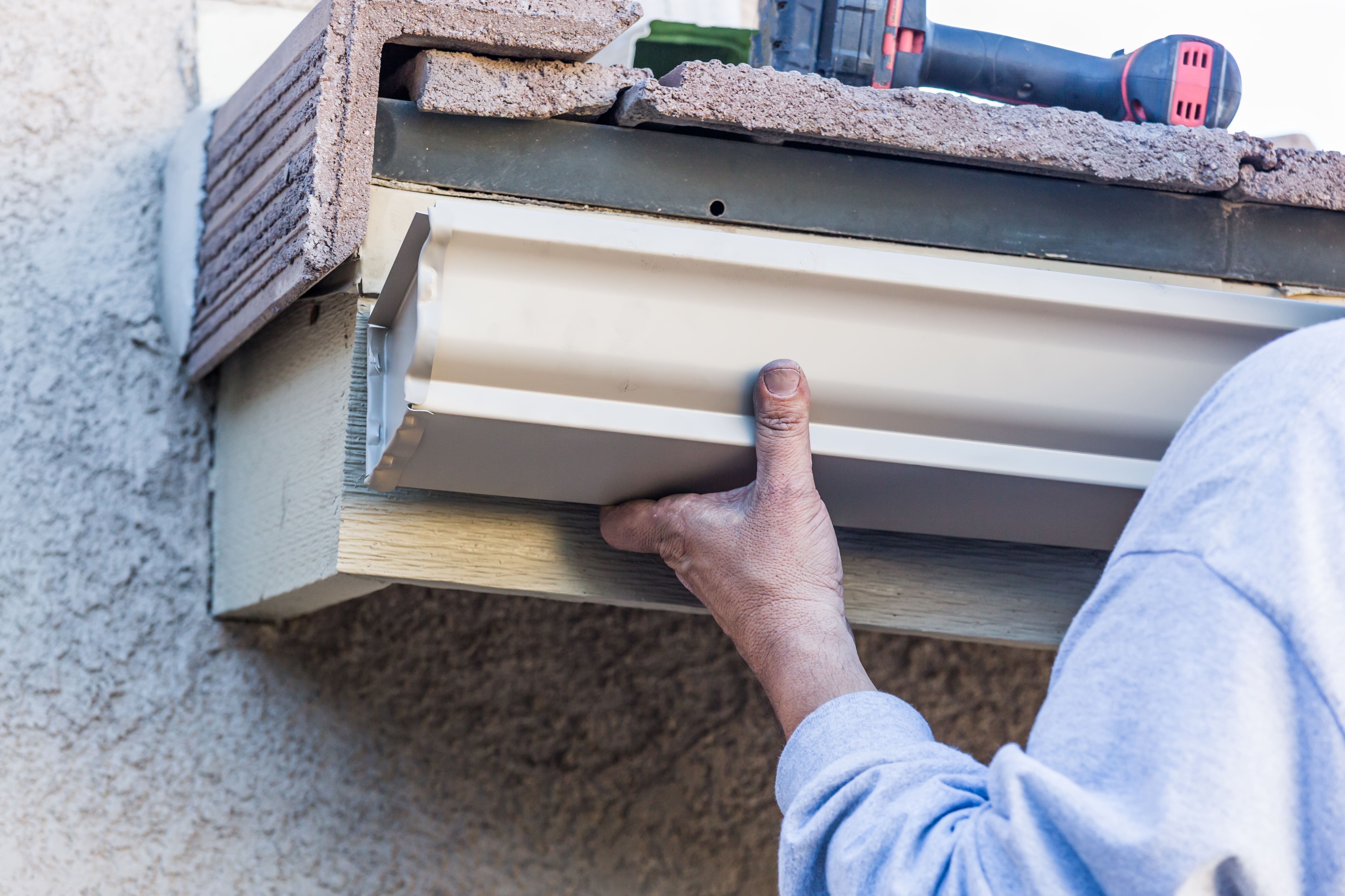 Expert installing the gutter