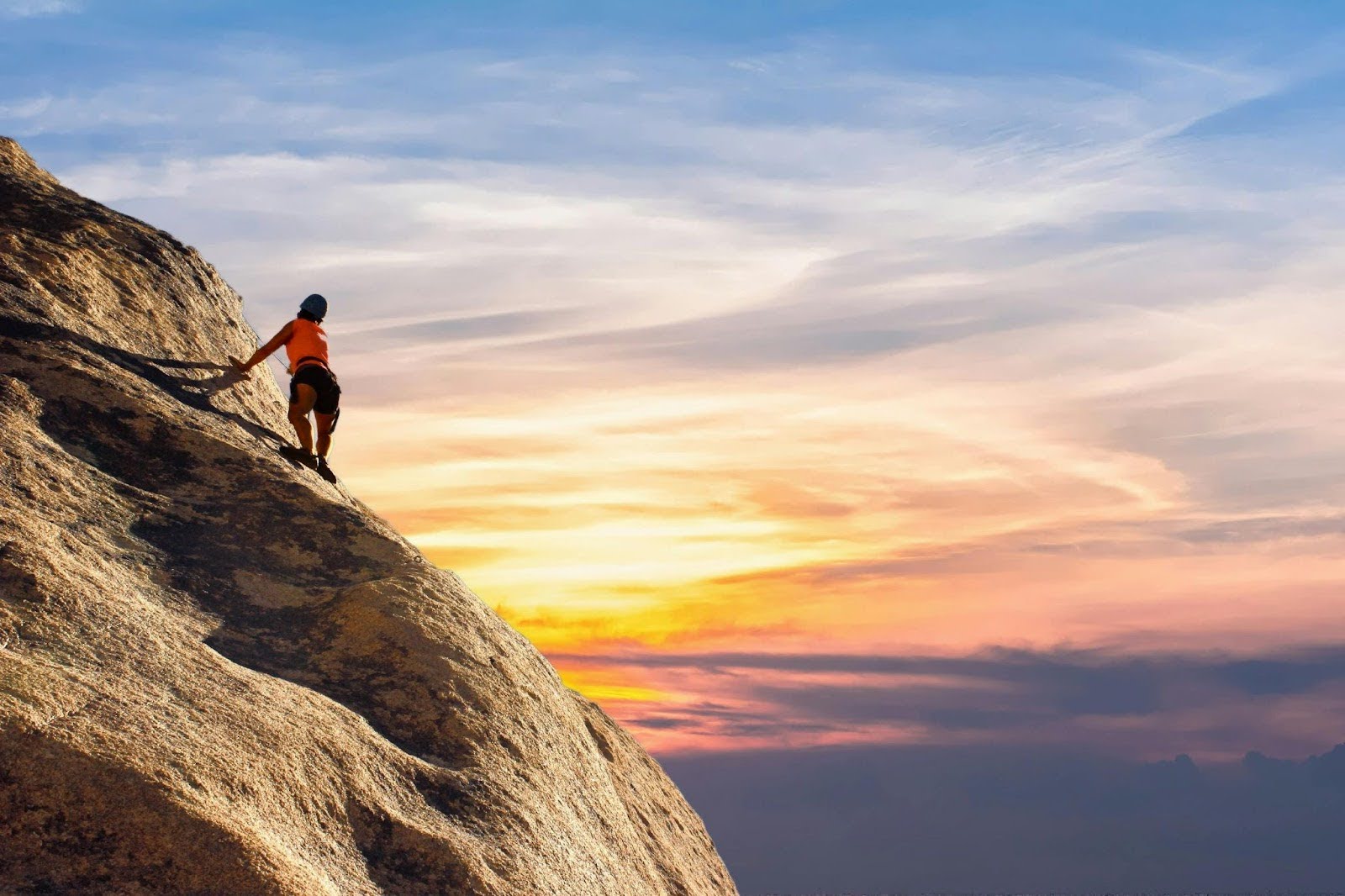 An image of a woman climbing a mountain, representing her facing a challenge An image of a woman climbing a mountain, representing her facing a challenge