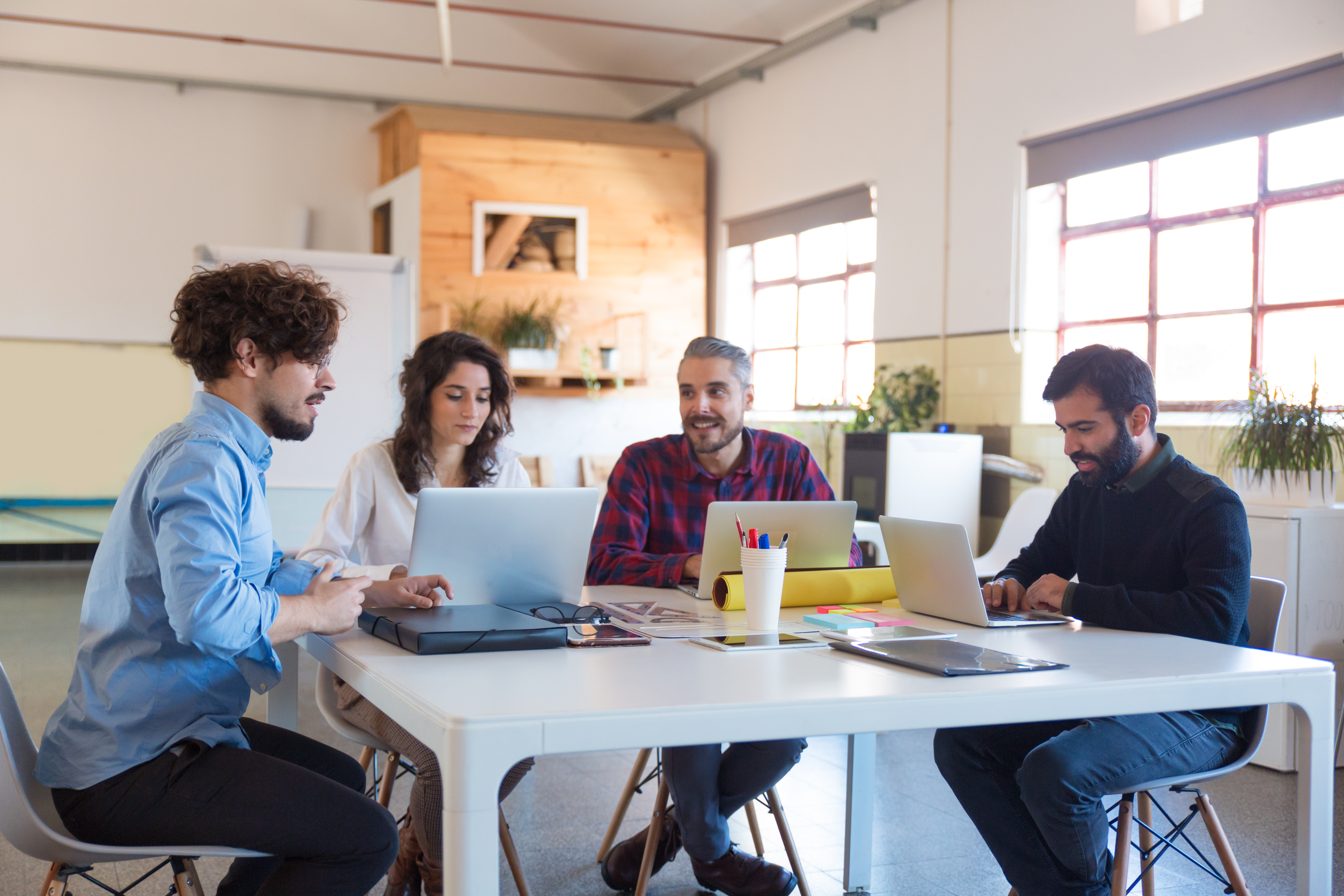 A startup team collaborating around a laptop.