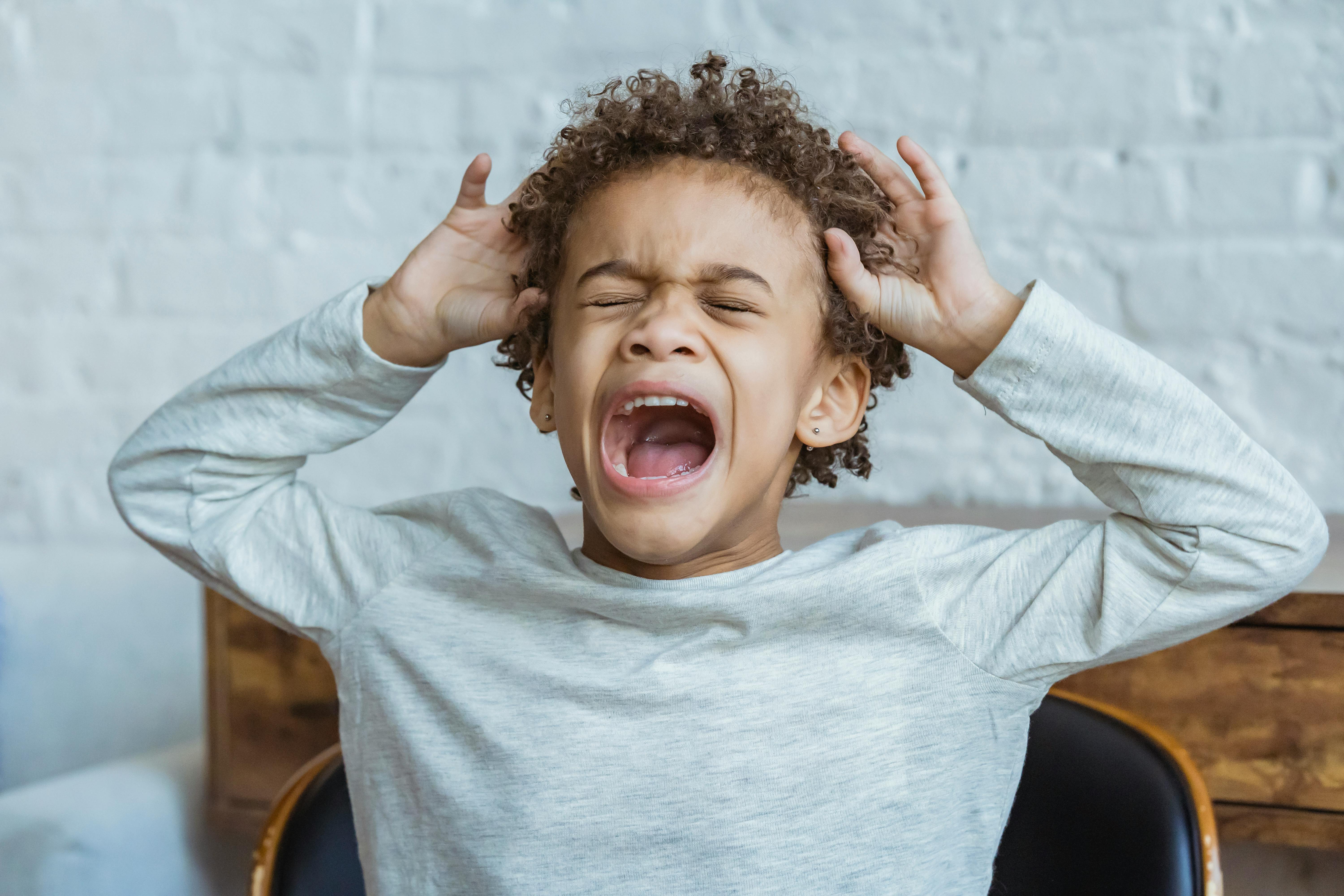 Boy screaming out of frustration