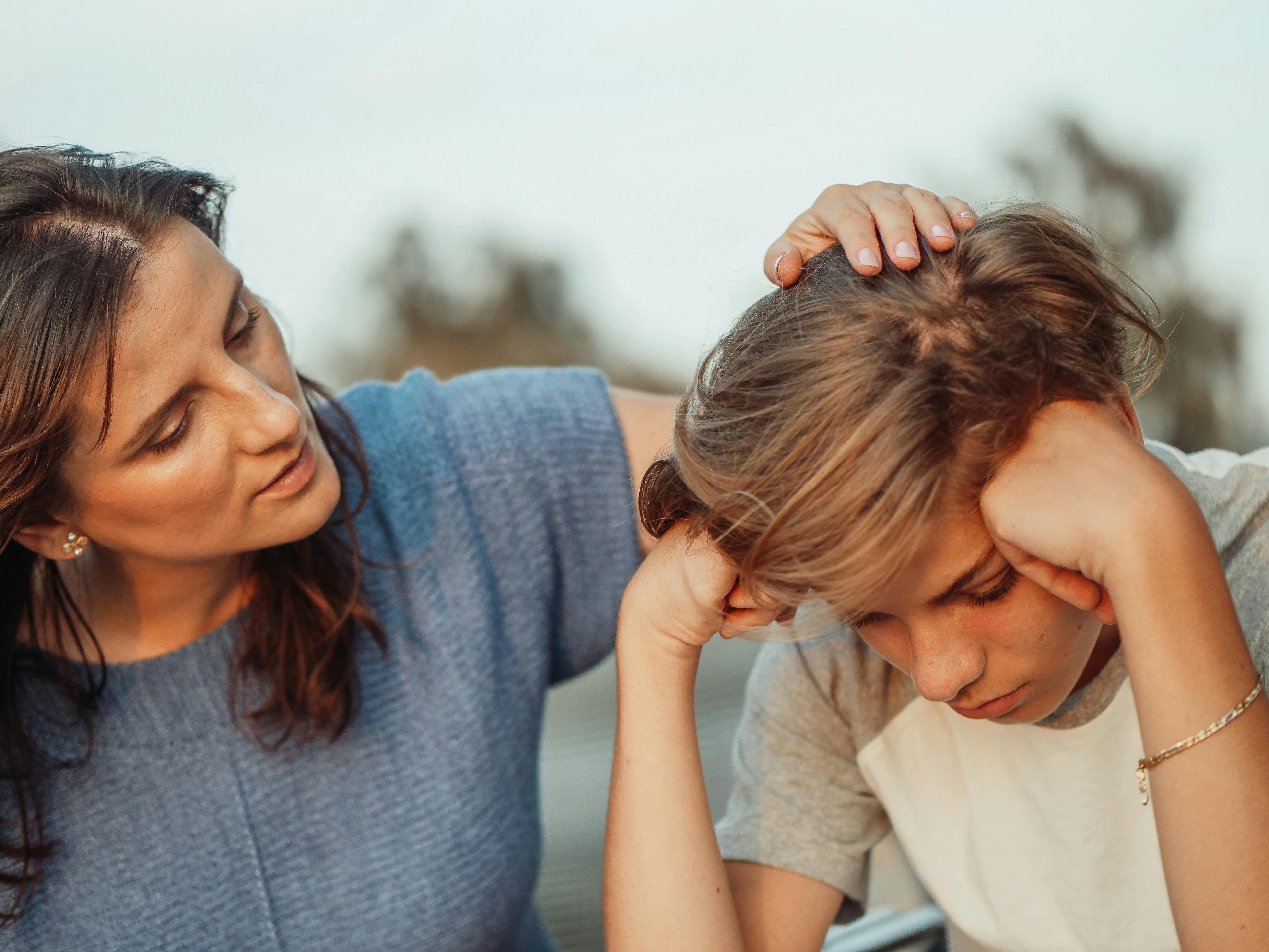 Mother listening and comforting her teenage son.