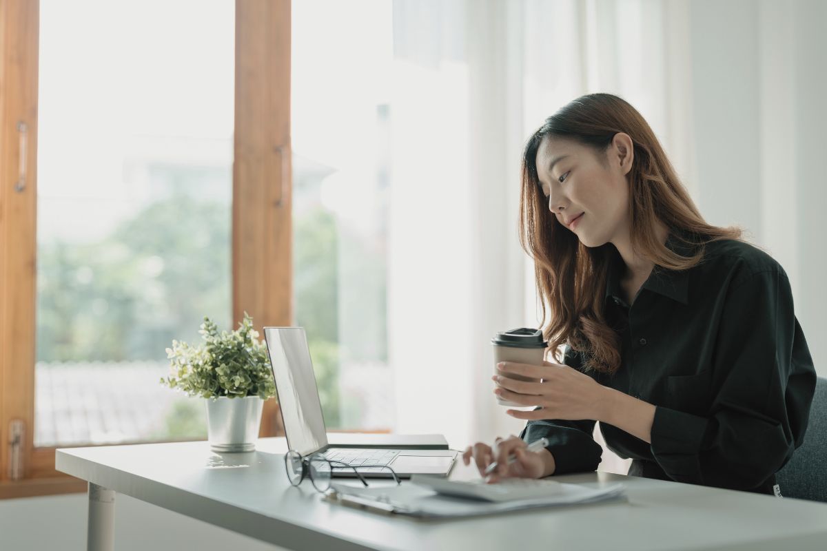 dark haired woman working with a coffee, being a girl boss dark haired woman working with a coffee, being a girl boss