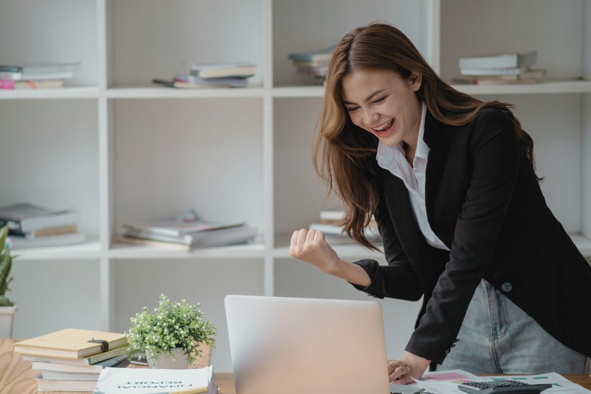 dark haired woman getting excited about being a boss babe dark haired woman getting excited about being a boss babe