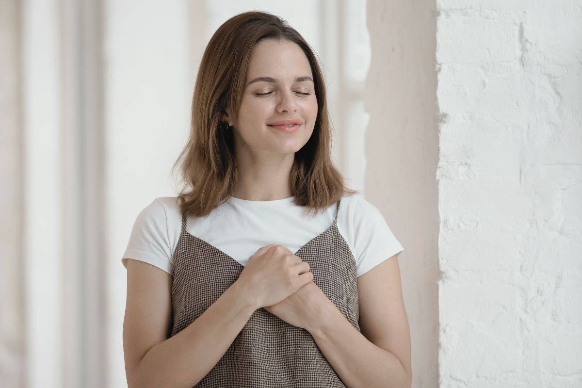 woman with brown hair feeling very grateful woman with brown hair feeling very grateful
