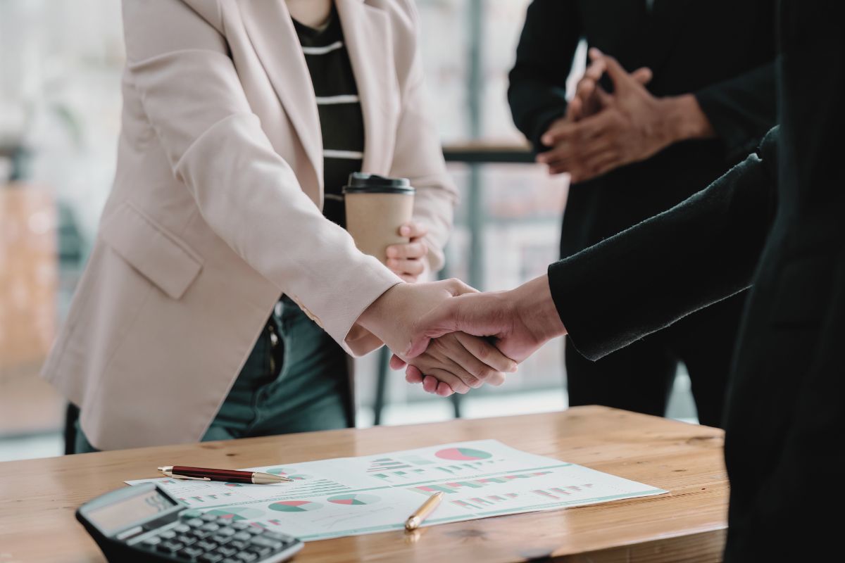 Woman with a coffee in one hand, making a real purposeful business transaction, Woman with a coffee in one hand, making a real purposeful business transaction,