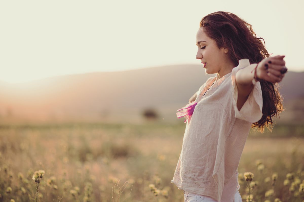 dark haired woman standing with outstretched arms, embracing her life with no ego dark haired woman standing with outstretched arms, embracing her life with no ego