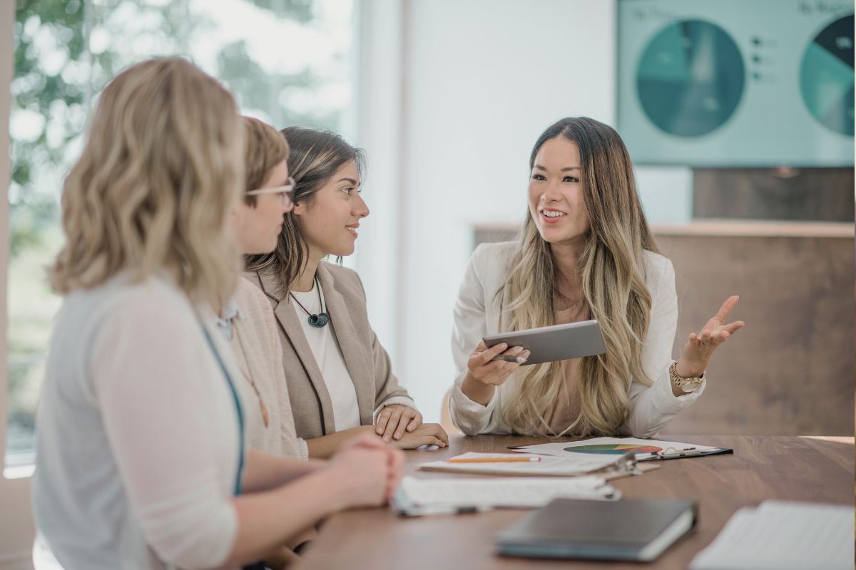 A few women in a meeting, building rapport A few women in a meeting, building rapport