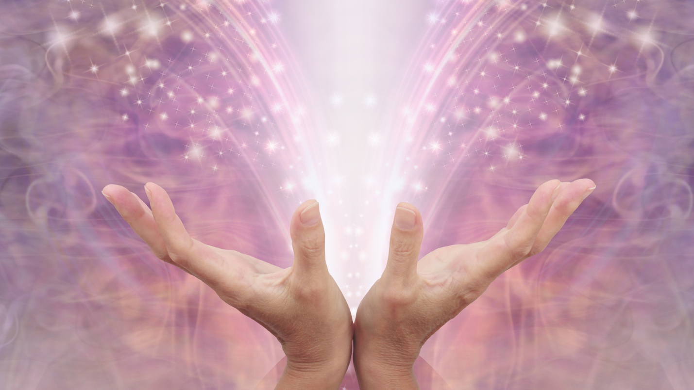 Hands glowing with light and sparkles emerging from the center, against a purple mystical background. Hands glowing with light and sparkles emerging from the center, against a purple mystical background.