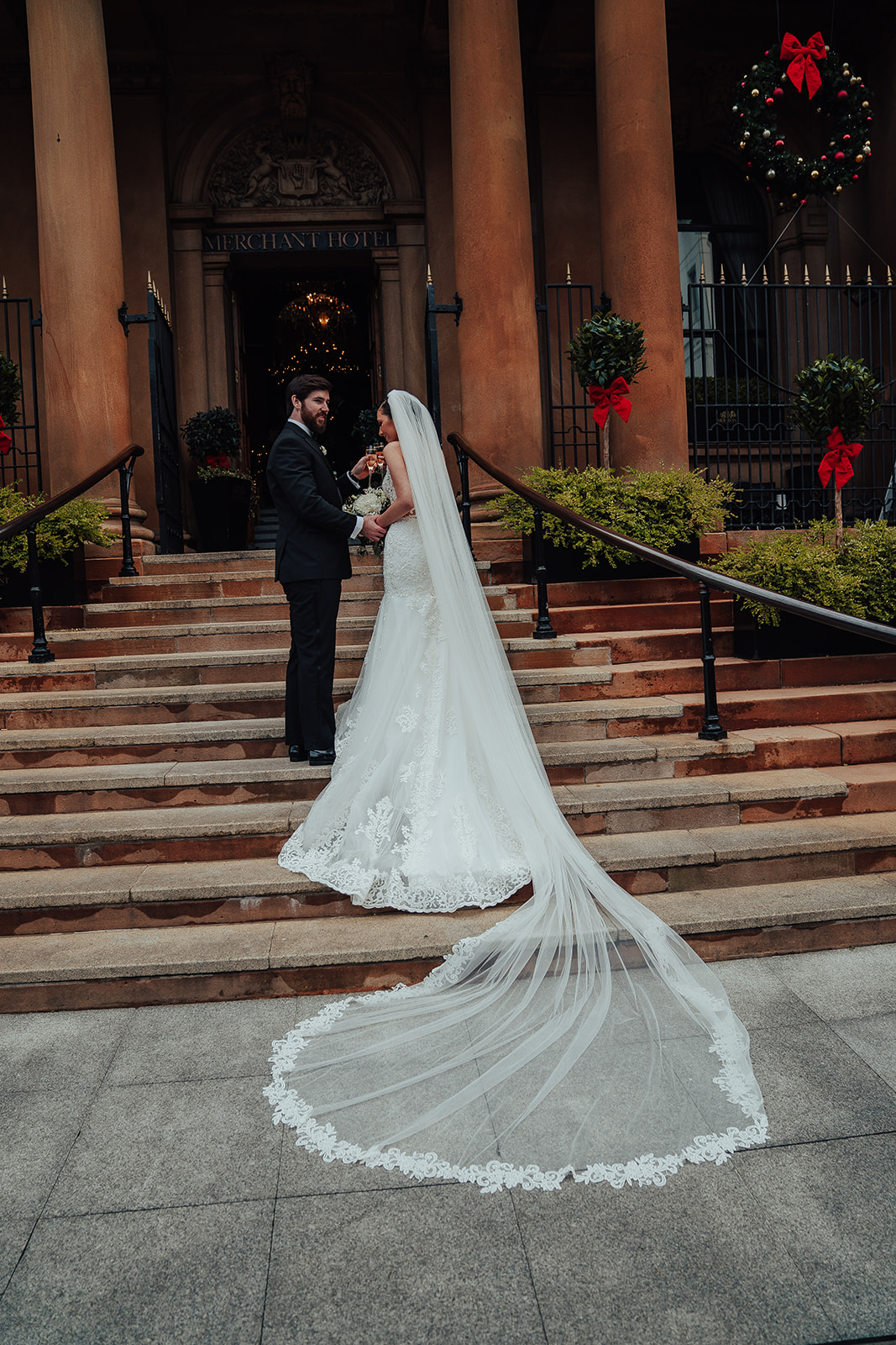 Bride and groom outside The Merchant Hotel Belfast on wedding day